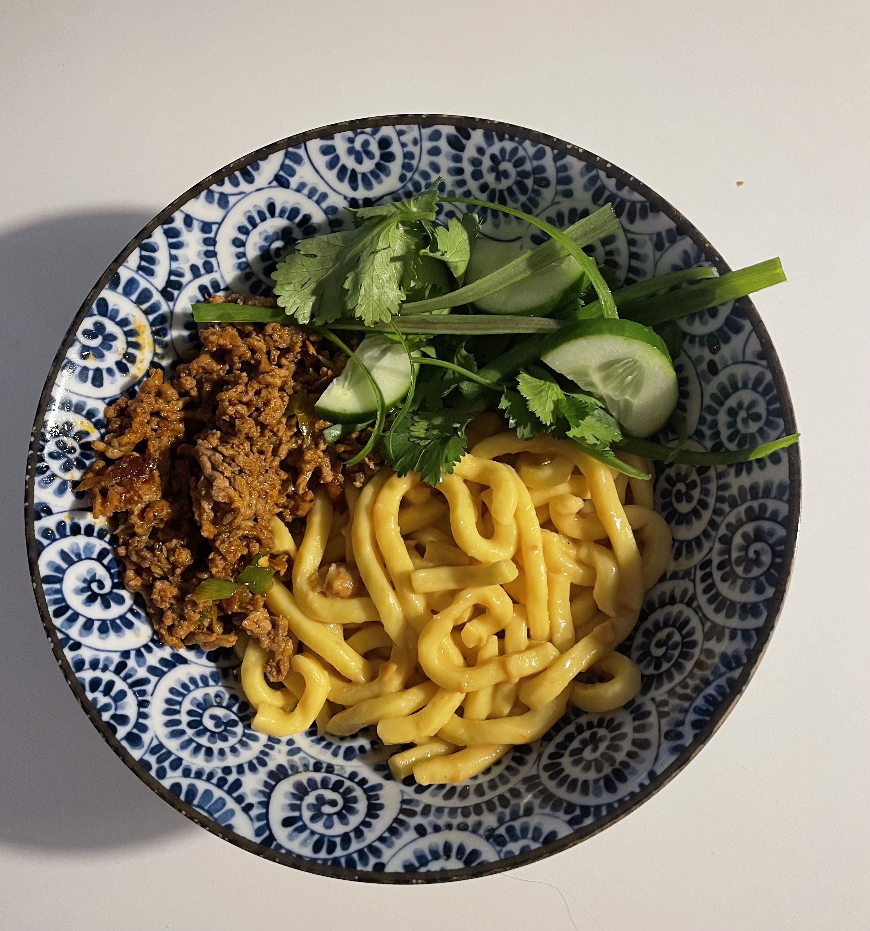 Spicy peanut noodles with mince, cucumber and coriander